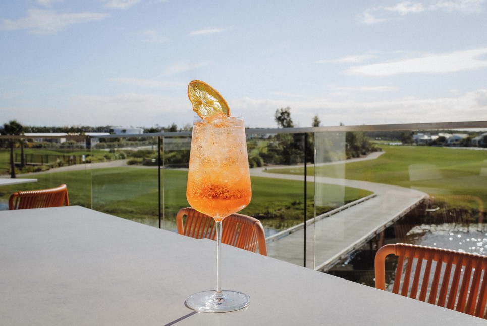 cocktail on terrace table overlooking golf course